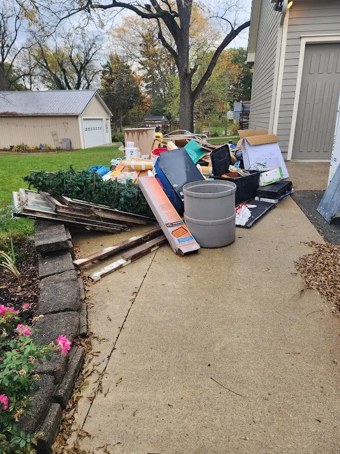 Dumpster being loaded with debris for 12 Yard Dumpster Rental in Millersburg